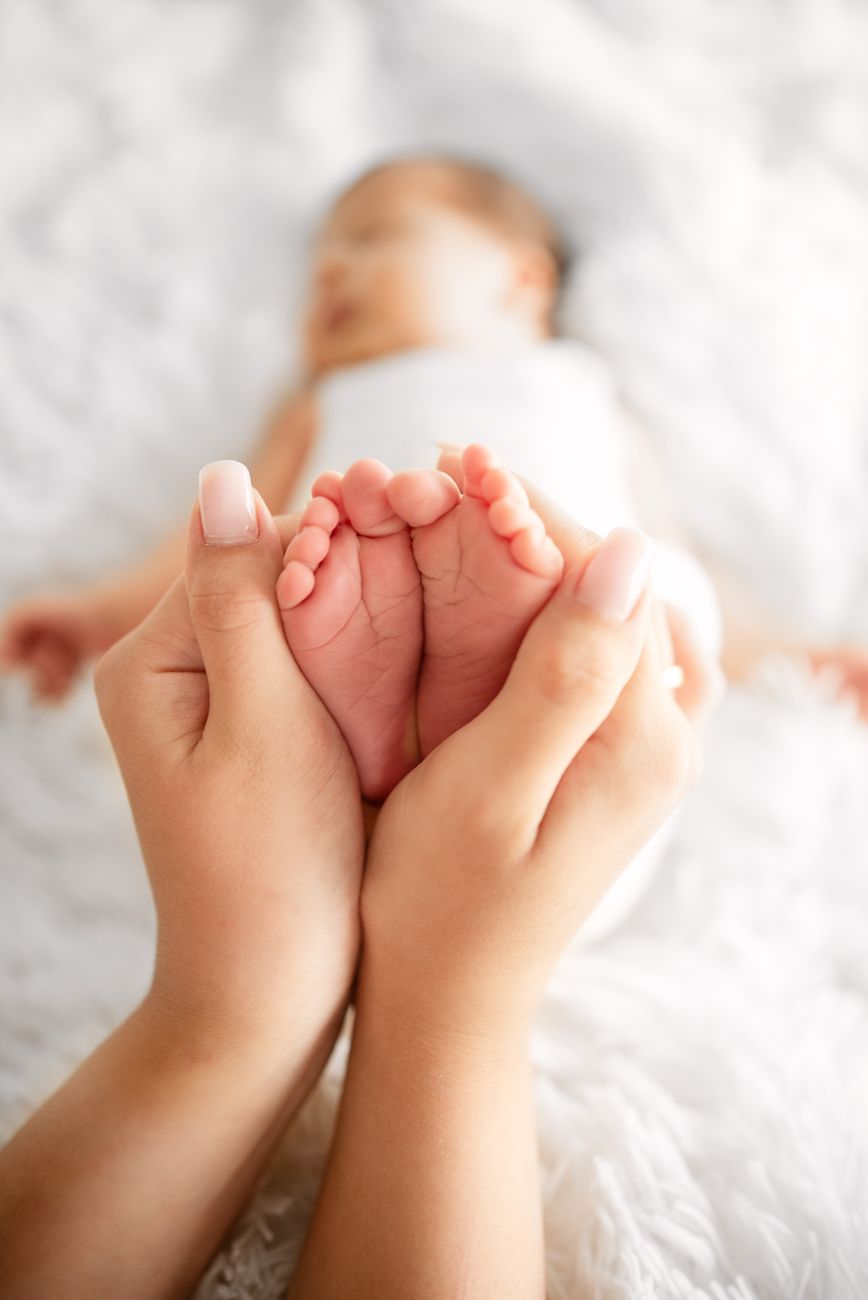 tender newborn foot in parent s hands